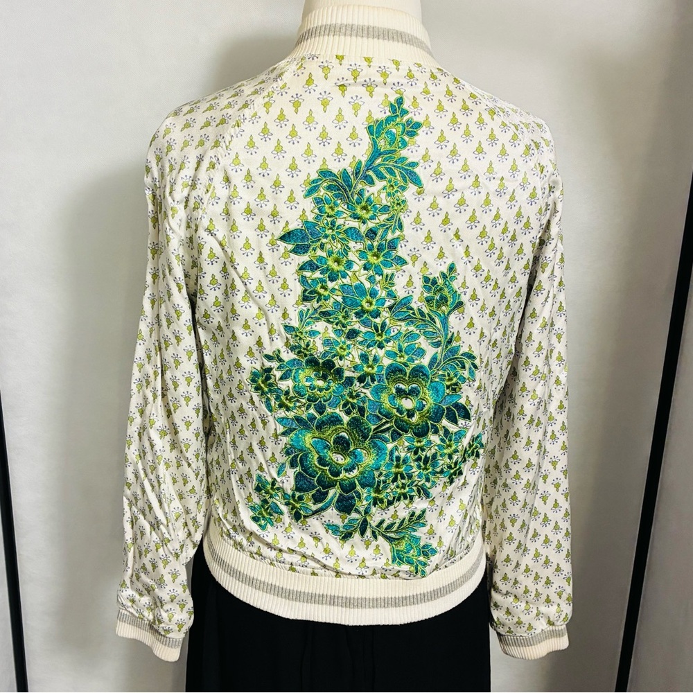 Green and white jacket with floral embroidery on back